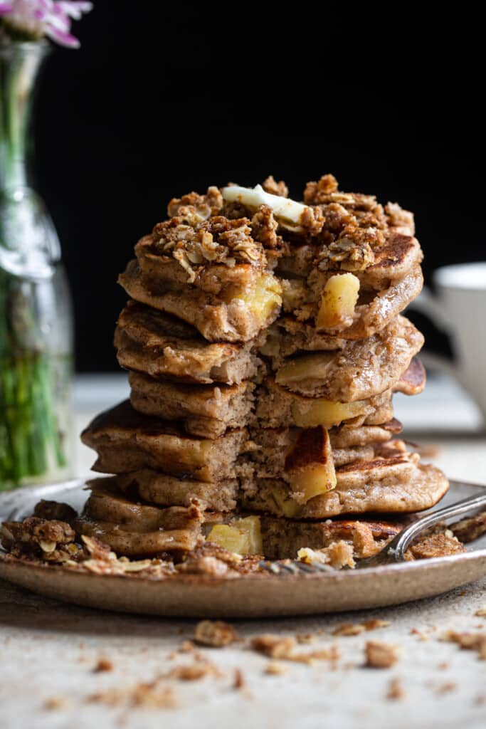 stack of healthy apple pancakes with a chunk eaten