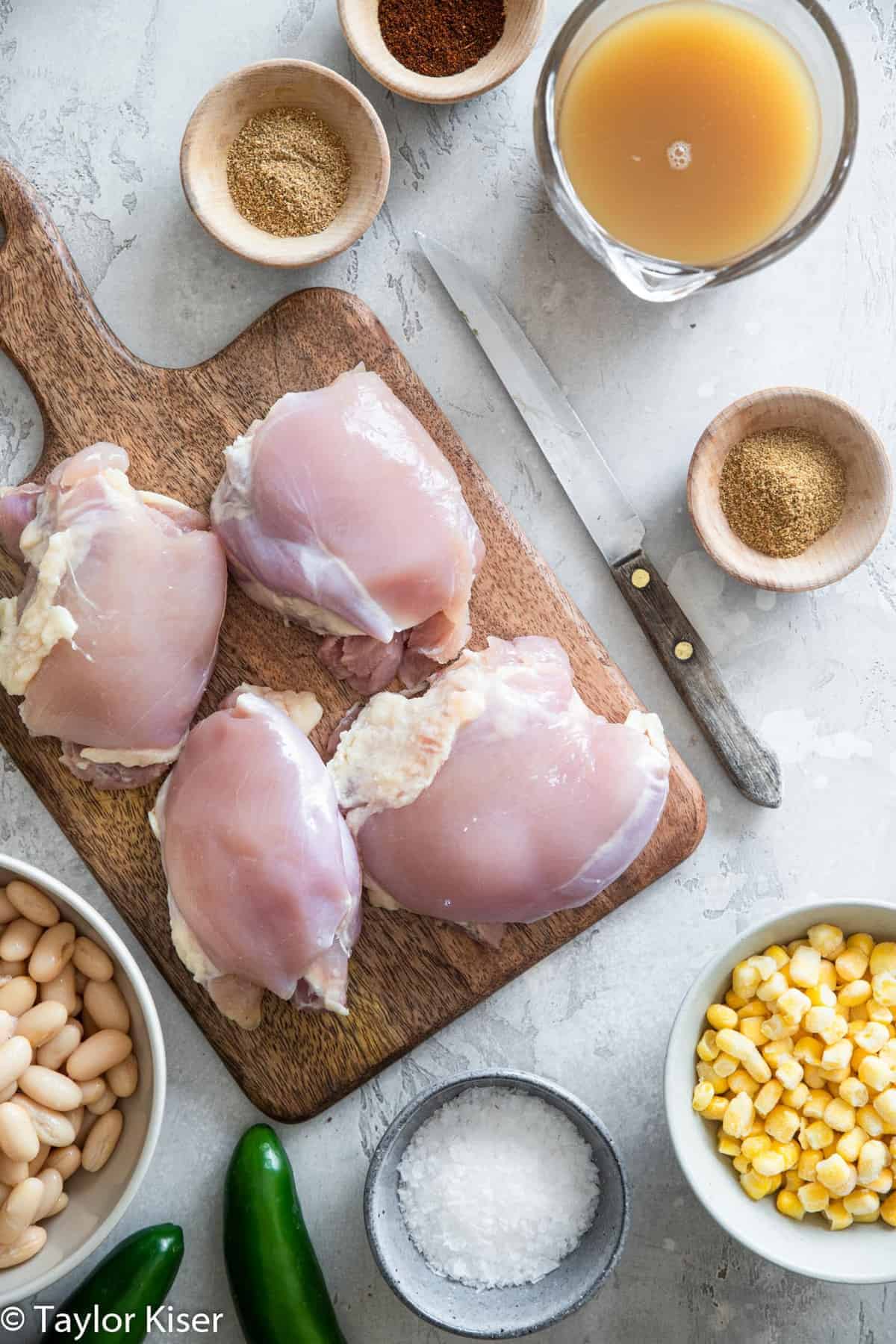 chicken breasts on a cutting board for Crockpot White Chicken Chili 