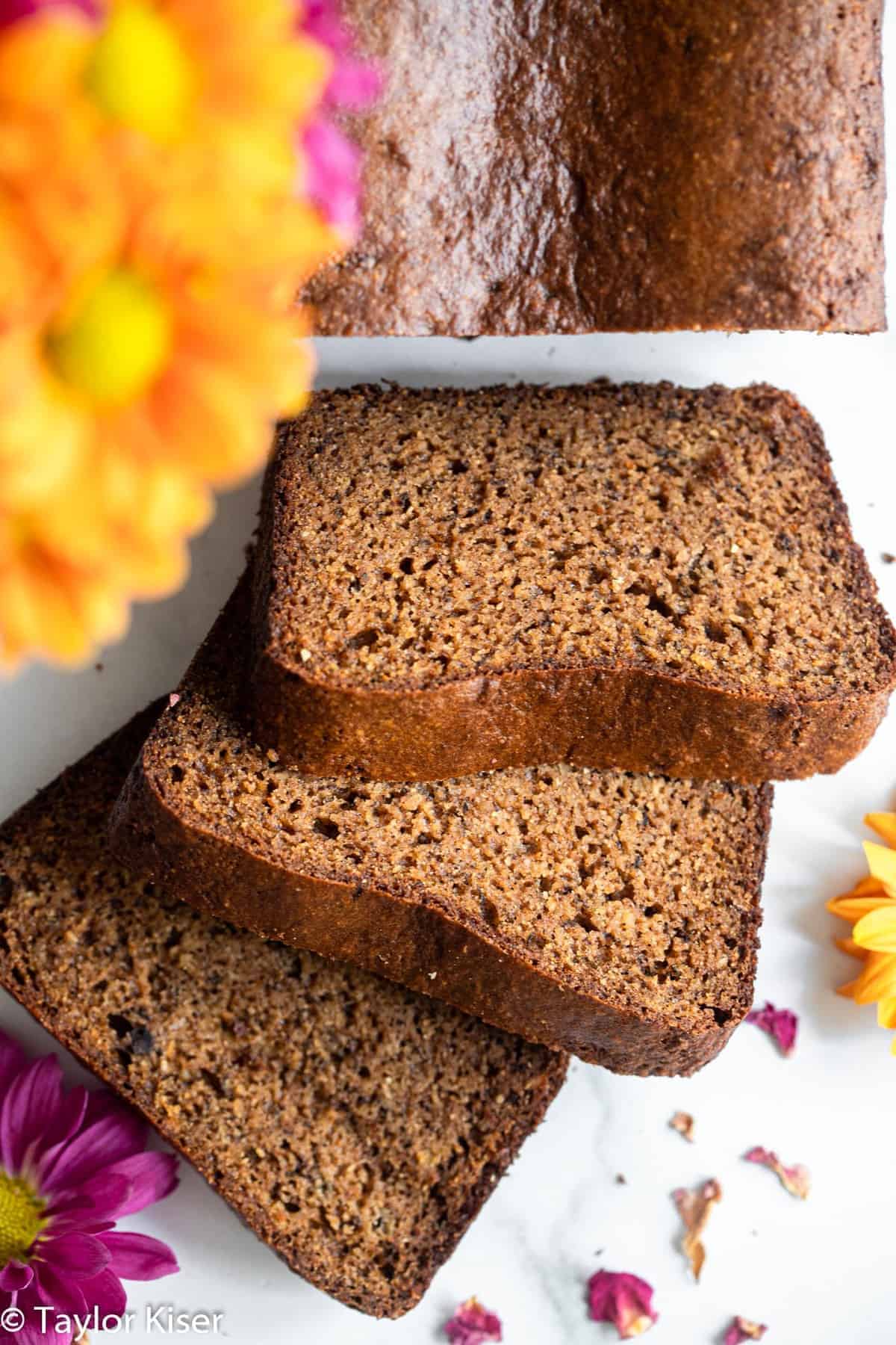 Slices of protein banana bread with flowers on a table