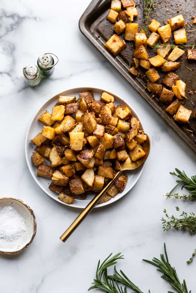 a bowl and baking sheet of Roasted Russet Potatoes