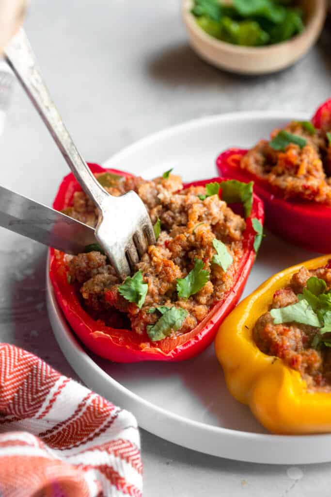 a Whole30 Stuffed Pepper on a plate being eaten